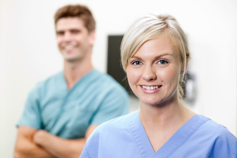 Young Female Vet In Scrubs Smiling